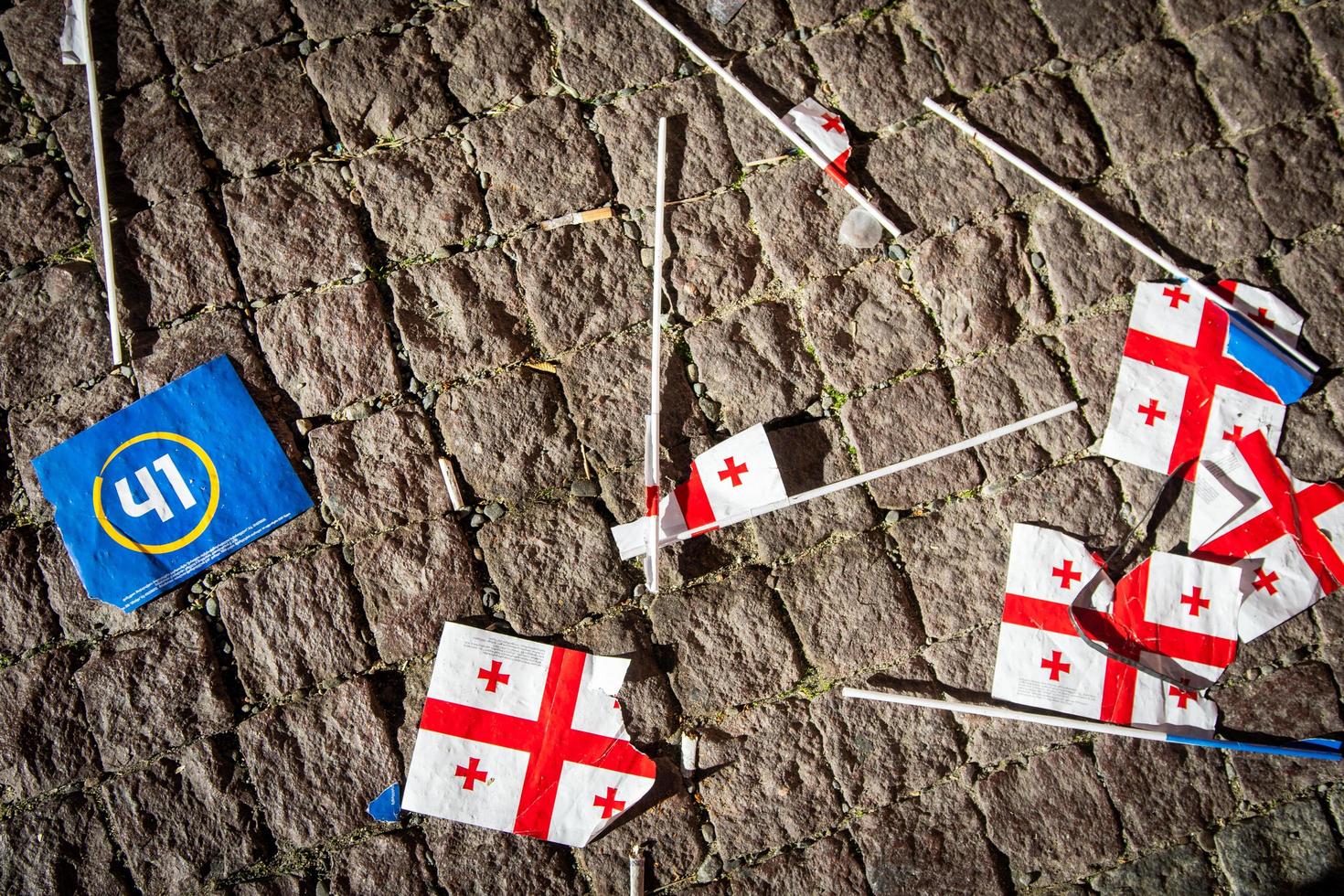 Georgian and dreamers party flags on ground in liberty square on democratic party Georgian dream political agitation event. Political powers in caucasus concept photo