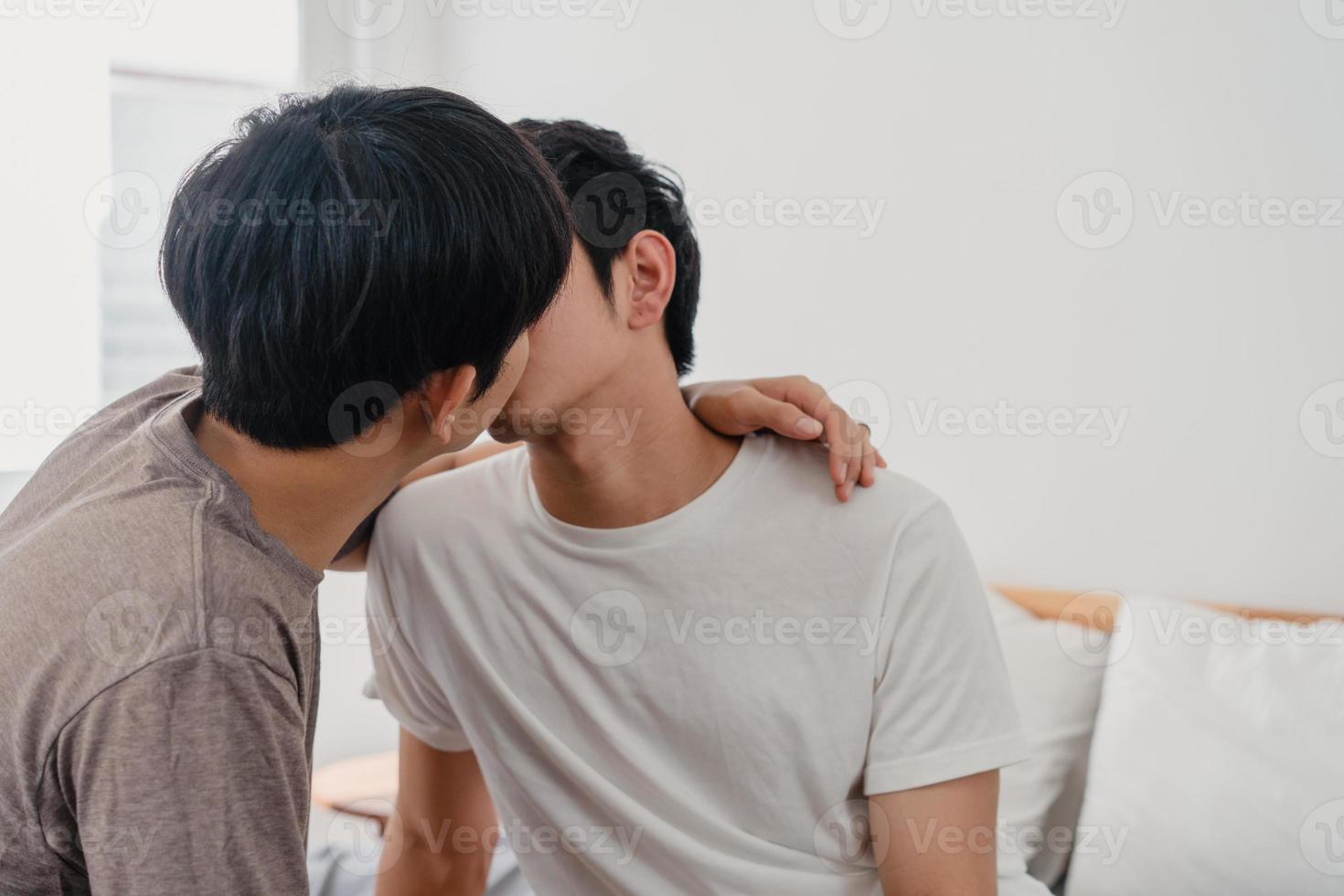 Asian Gay couple kissing on bed at home. Young Asian LGBTQ men happy relax rest together spend romantic time after wake up in bedroom at home in the morning concept. photo