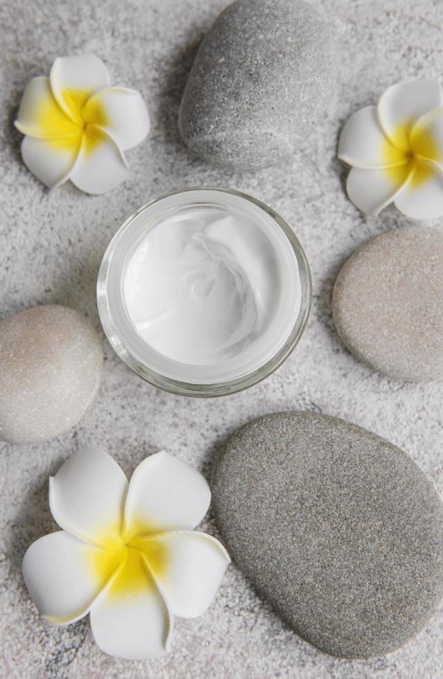 Spa treatment with massage stones and moisturizing cream photo
