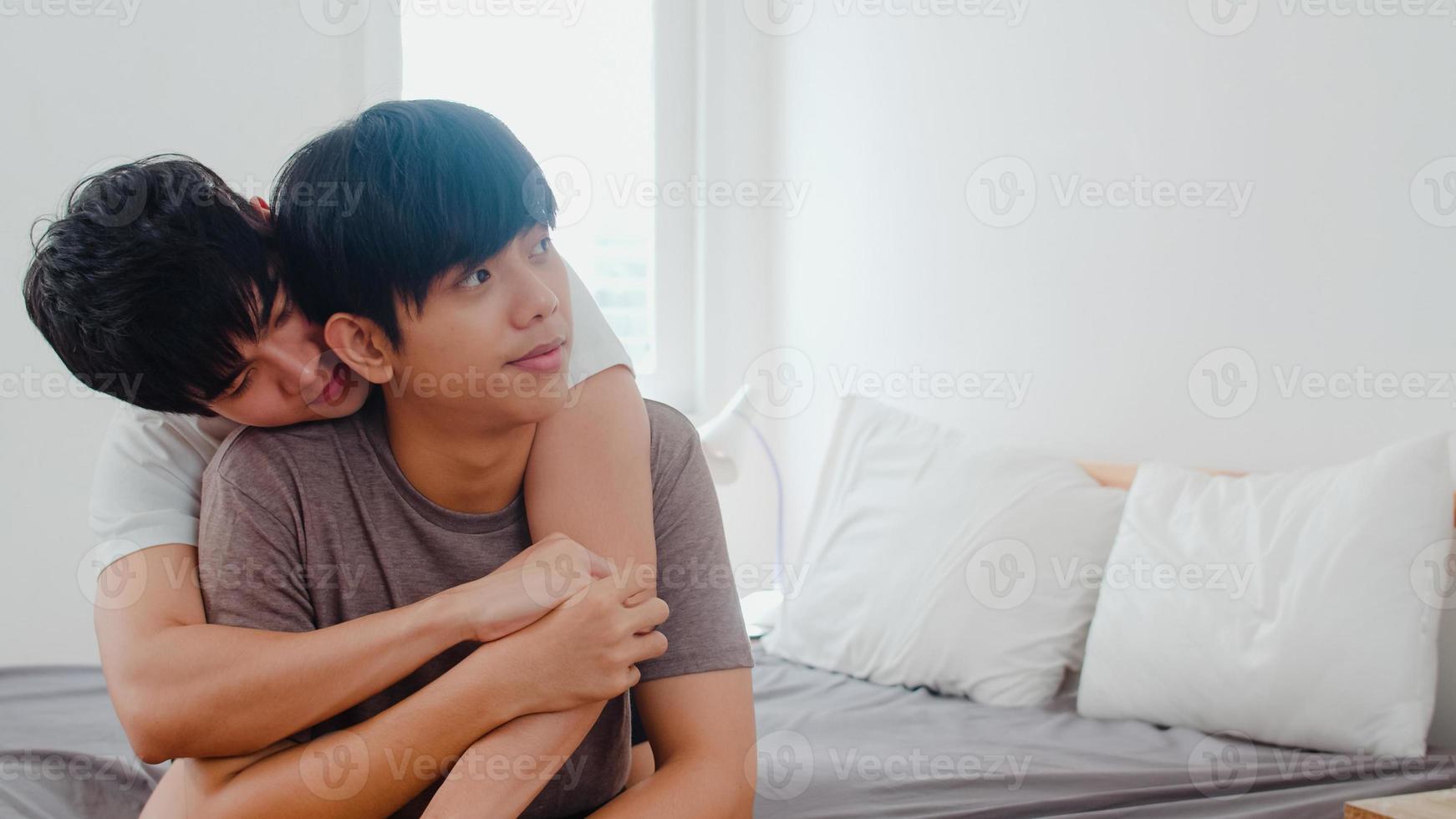 Asian Gay couple kissing on bed at home. Young Asian LGBTQ men happy relax rest together spend romantic time after wake up in bedroom at home in the morning concept. photo