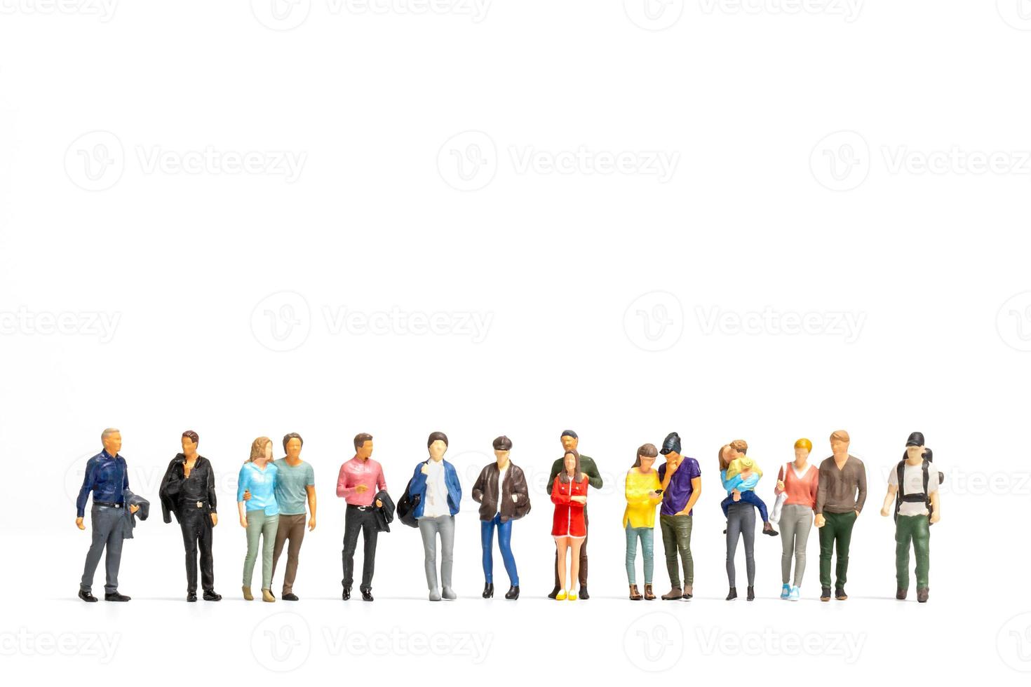 Group of Miniature people isolated on white background photo