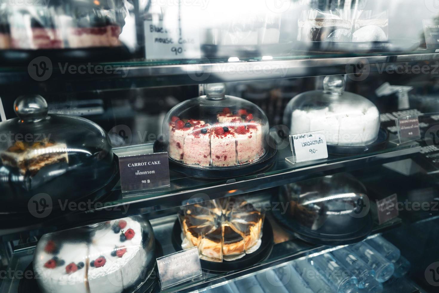 Fruit cakes in a glass cabinet at a coffee shop photo
