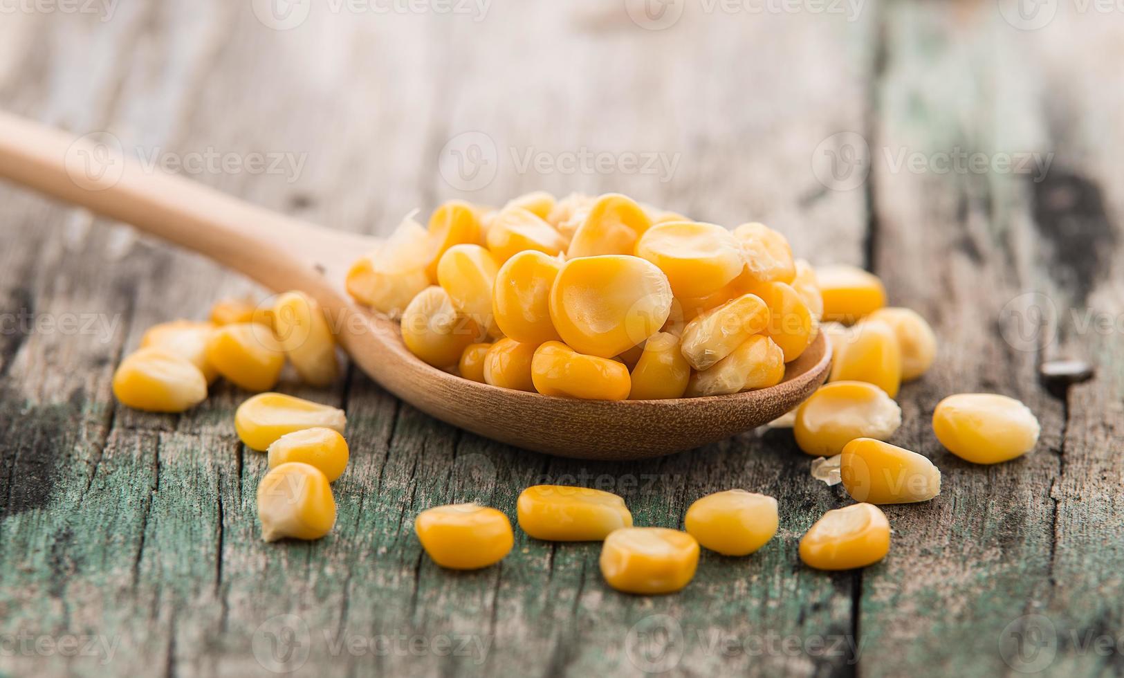 corn in the spoon on wooden photo