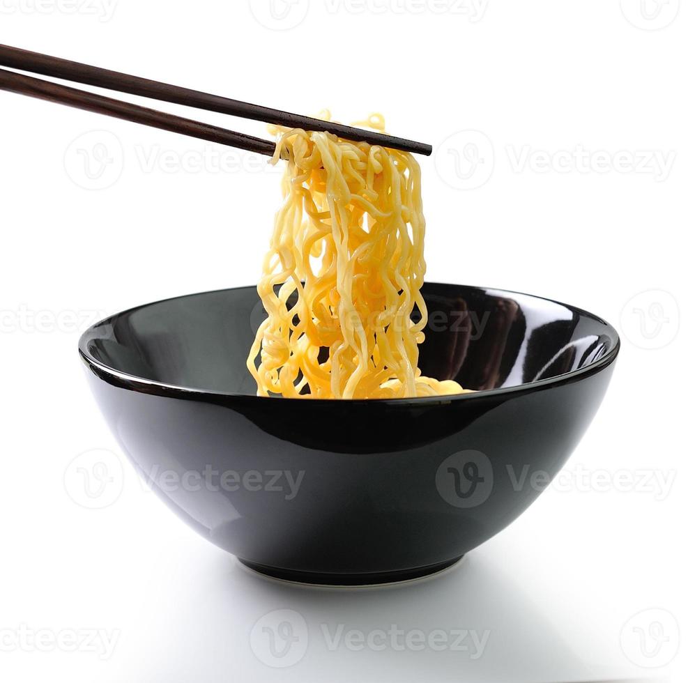 chopsticks holding noodles isolated on white background photo