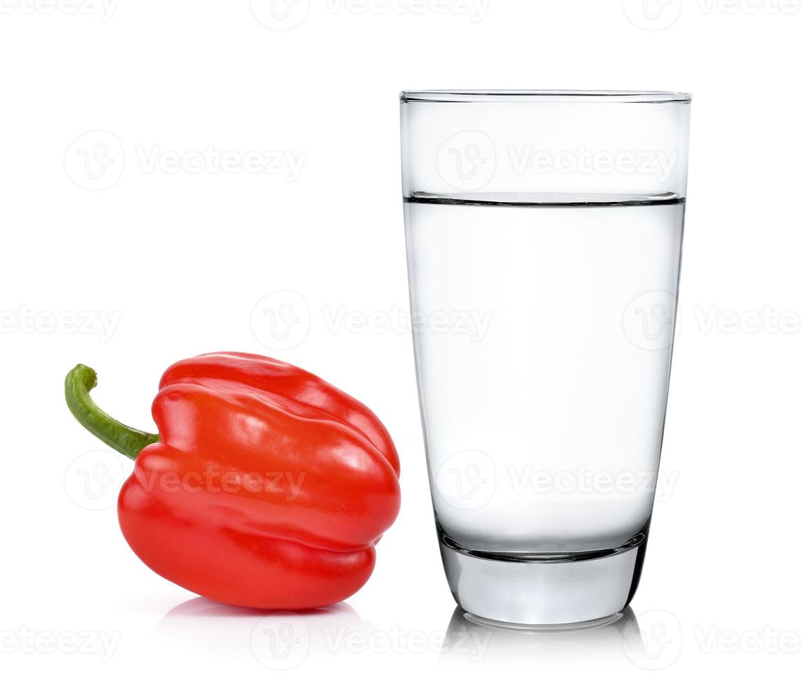 Glass of water and pepper isolated on white background photo