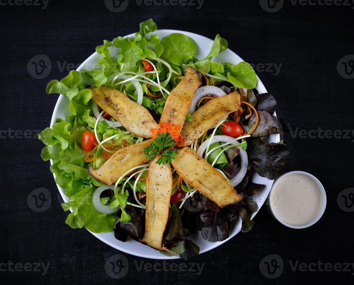 Mushroom salad on the white plate photo