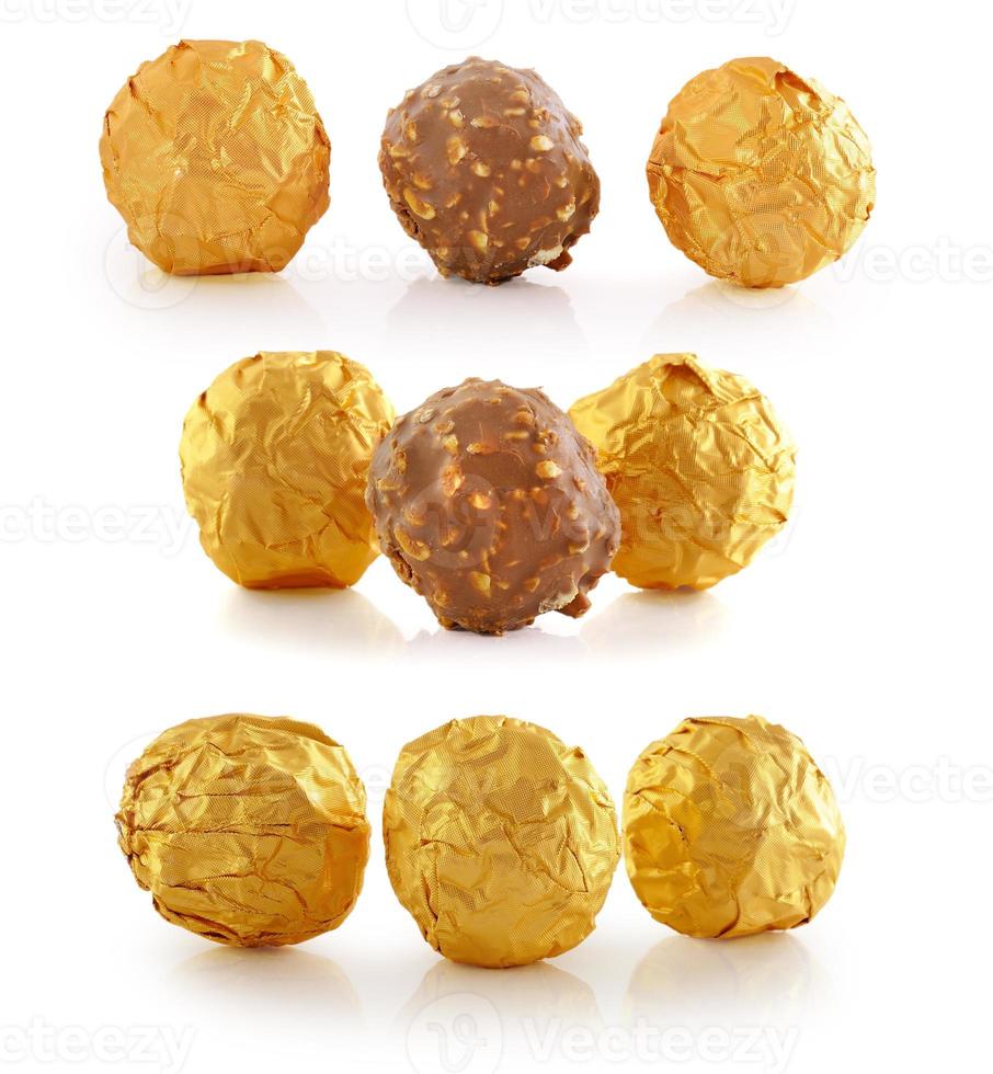 Sweet chocolate candy wrapped in golden foil isolated on white background photo