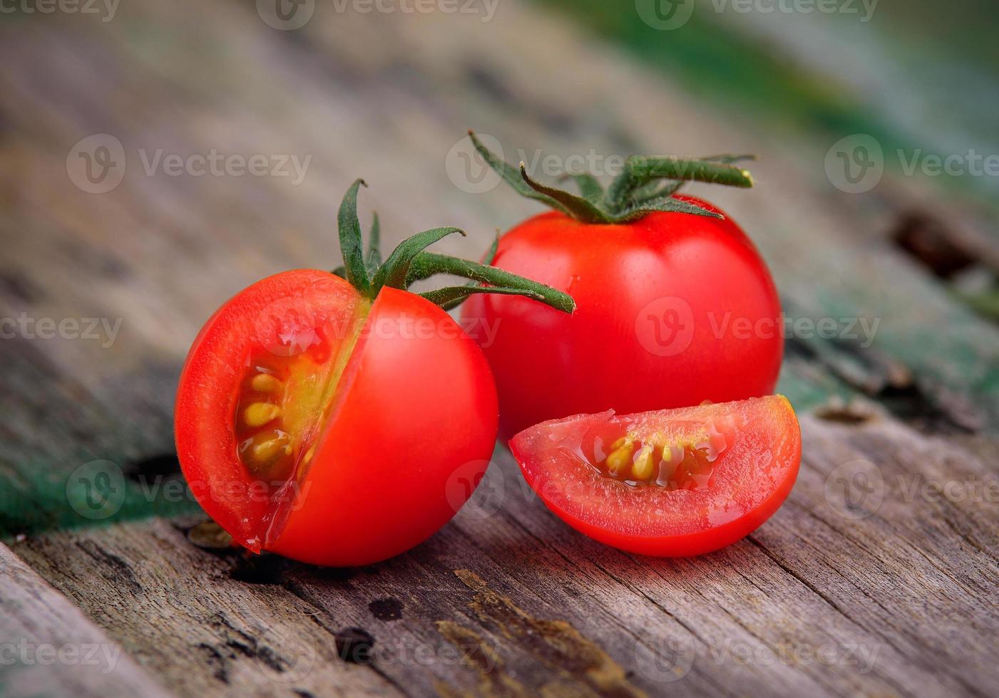 Close-up of fresh, ripe cherry tomatoes on wood photo