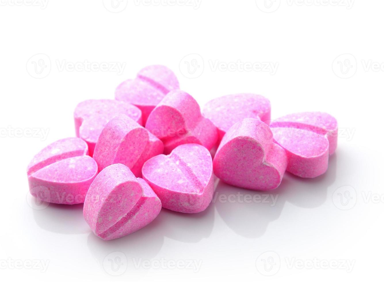 Heart of pills isolated on white background photo