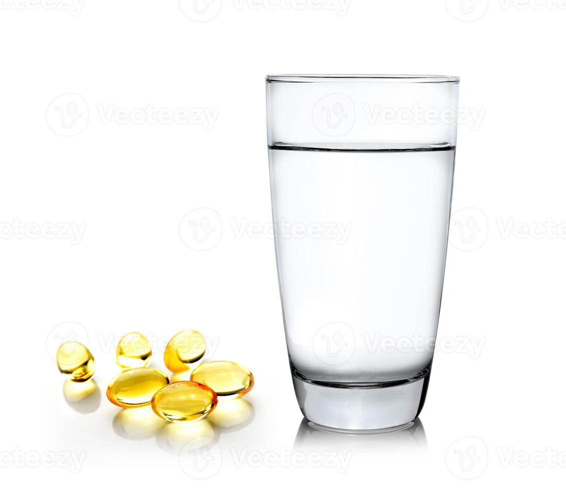 Glass of water and fish oil isolated on white background photo