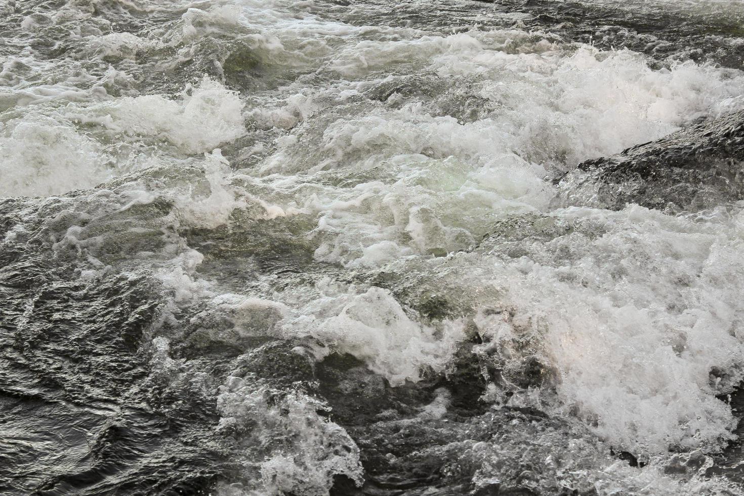 Fast flowing river water of waterfall Rjukandefossen, Hemsedal, Buskerud, Norway. photo