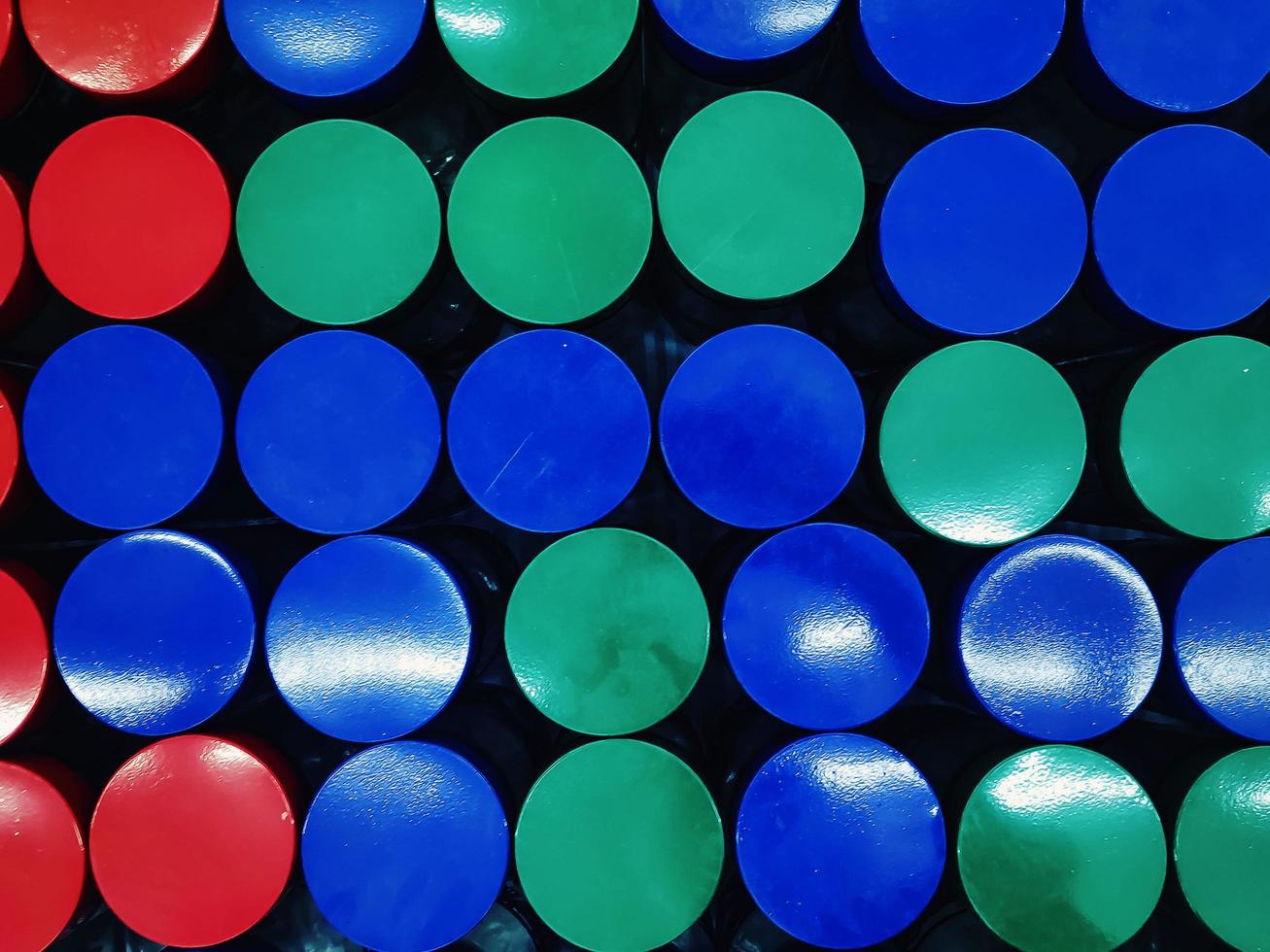 Colorful jar circle covers placed in a tight arrangement photo