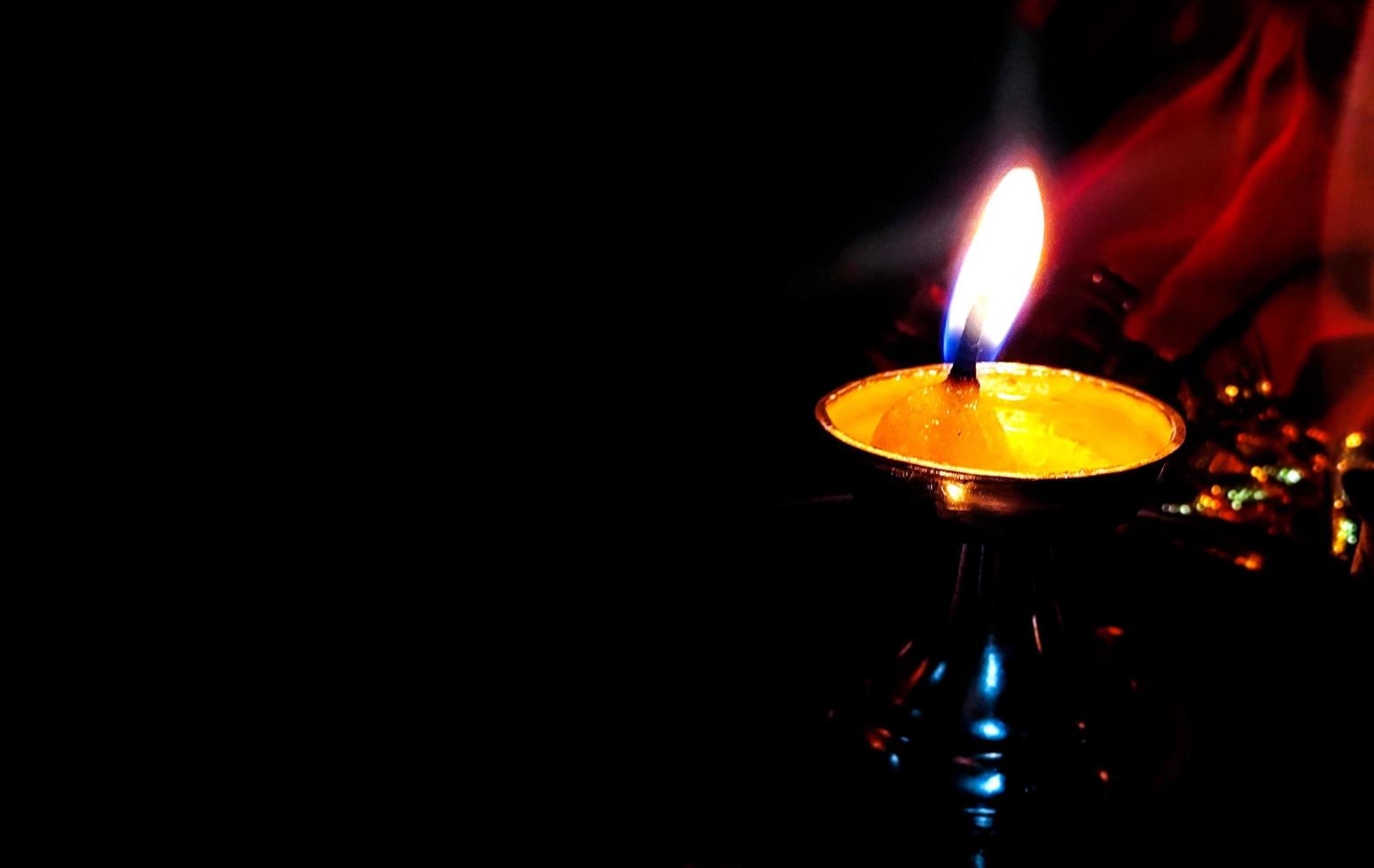 Soil or clay lamp radiating light in dark. photo