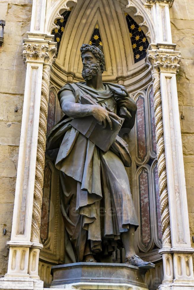 Statue of St. Luke by Giambologna, at Orsanmichele church exterior in Florence, Italy photo