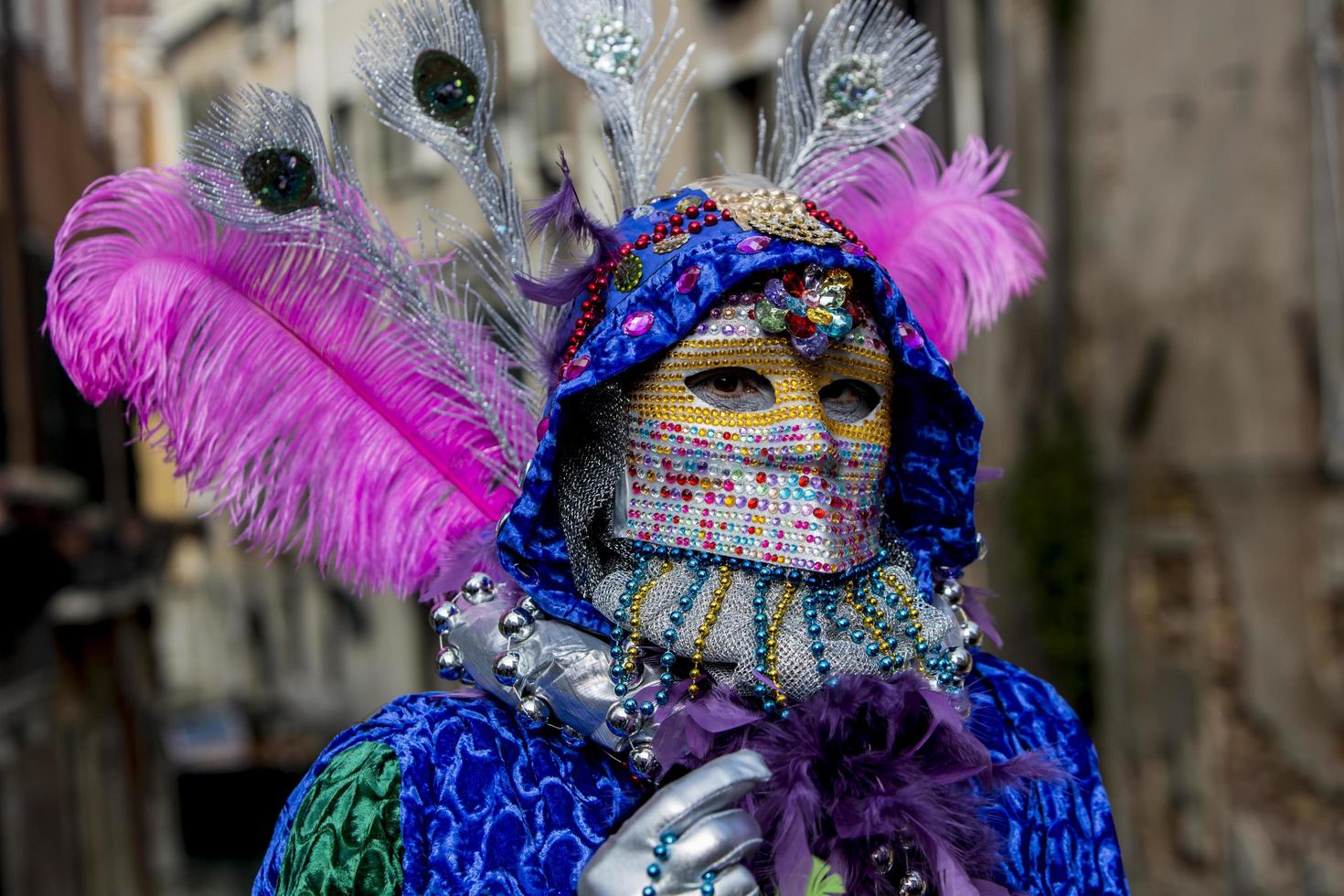 VENICE, ITALY, FEBRUARY 10, 2013 - Unidentified person with Venetian carnival mask in Venice, Italy. At 2013 it is held from January 26th to February 12th. photo