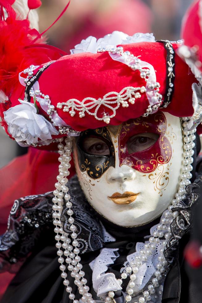 VENICE, ITALY, FEBRUARY 10, 2013 - Unidentified person with Venetian carnival mask in Venice, Italy. At 2013 it is held from January 26th to February 12th. photo