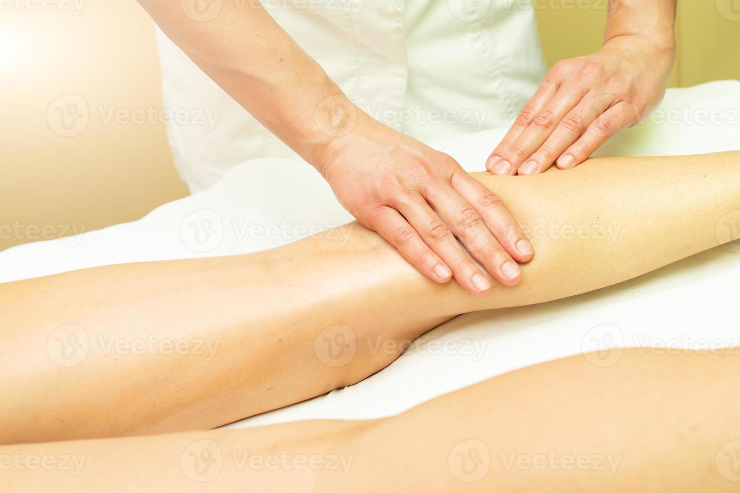 A calf aesthetic massage in an esthetic studio photo