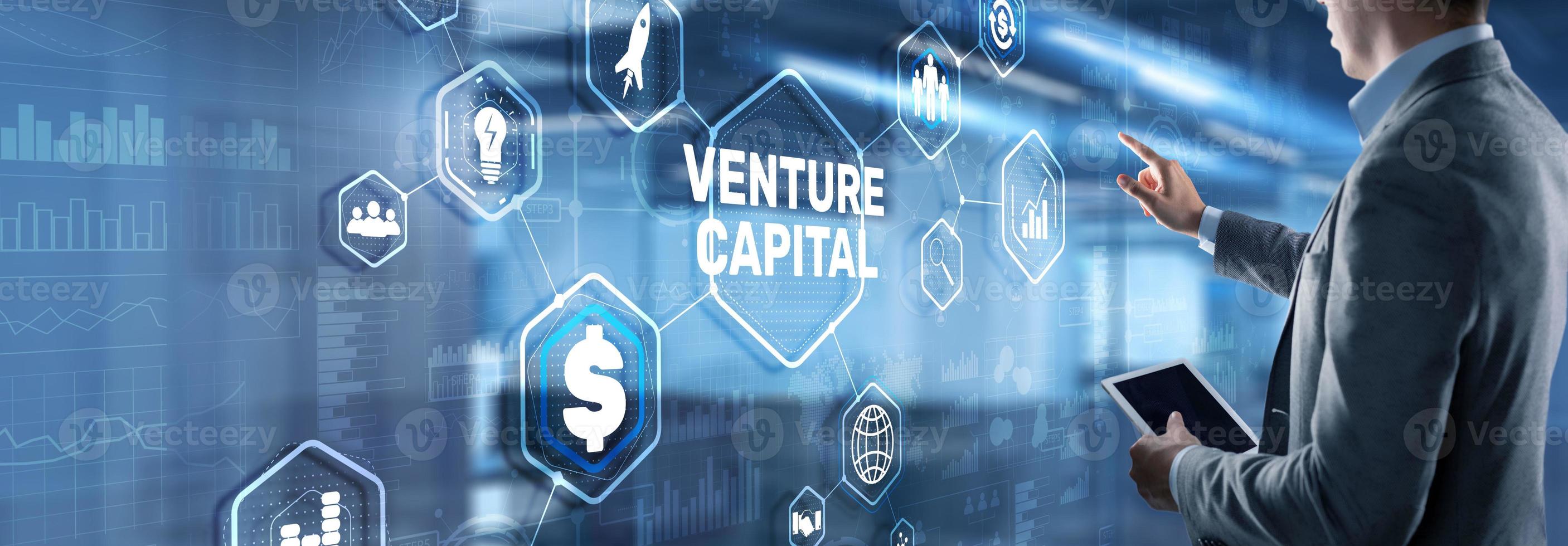 Venture capital. Investor capital. Businessman pressing virtual screen inscription photo