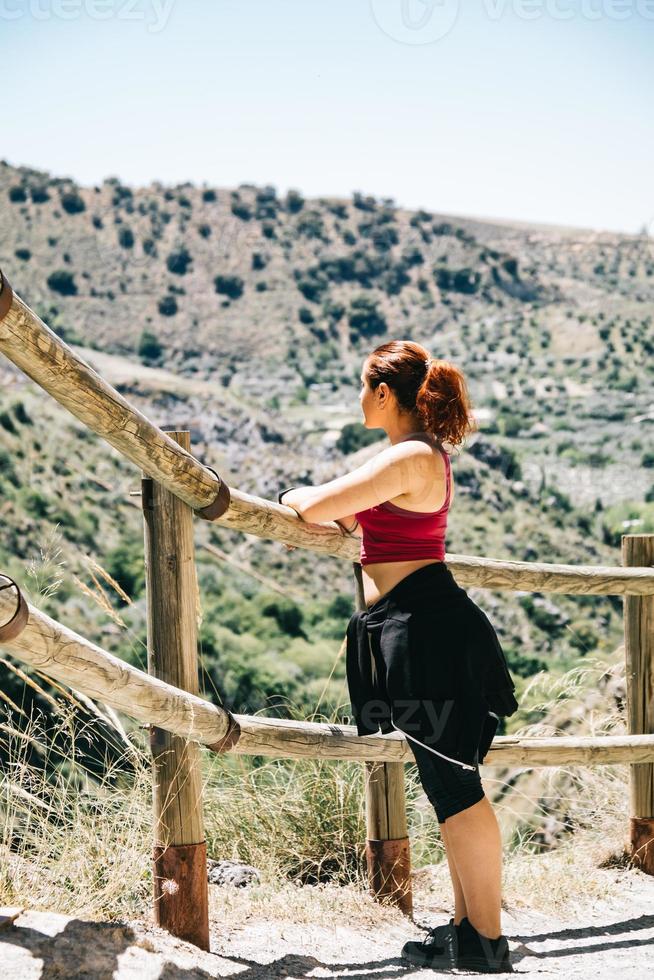 Happy young woman hiker watching the landscape photo