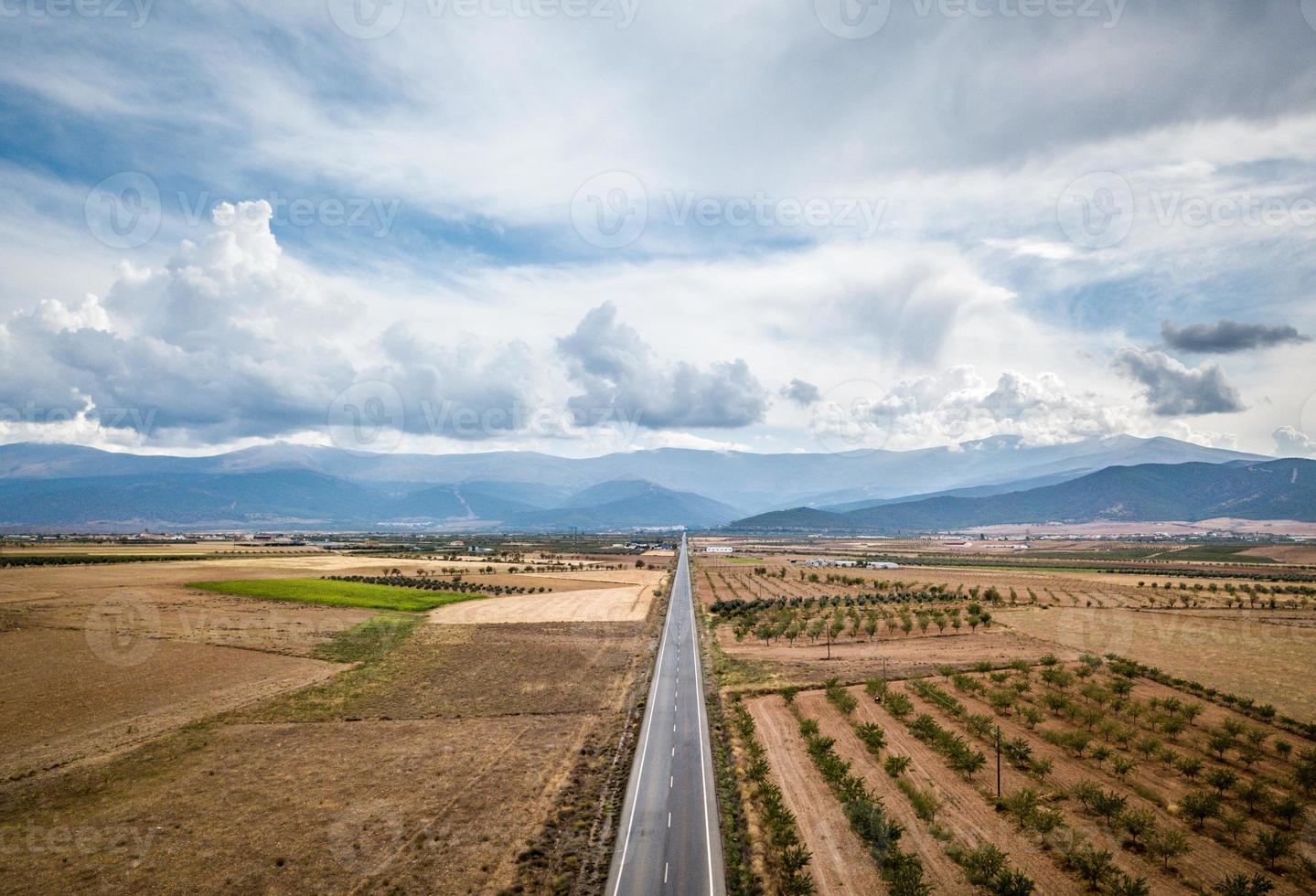 Aerial View Of Straight Tarred Road Through Guadix, Granada. In the background Sierra Nevada photo