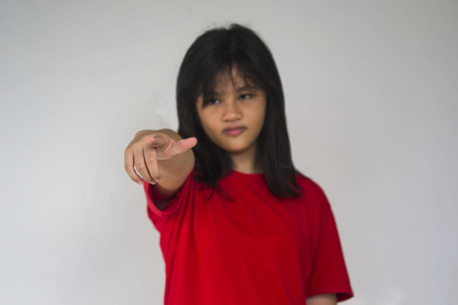 A beautiful young girl pinting with her index finger photo