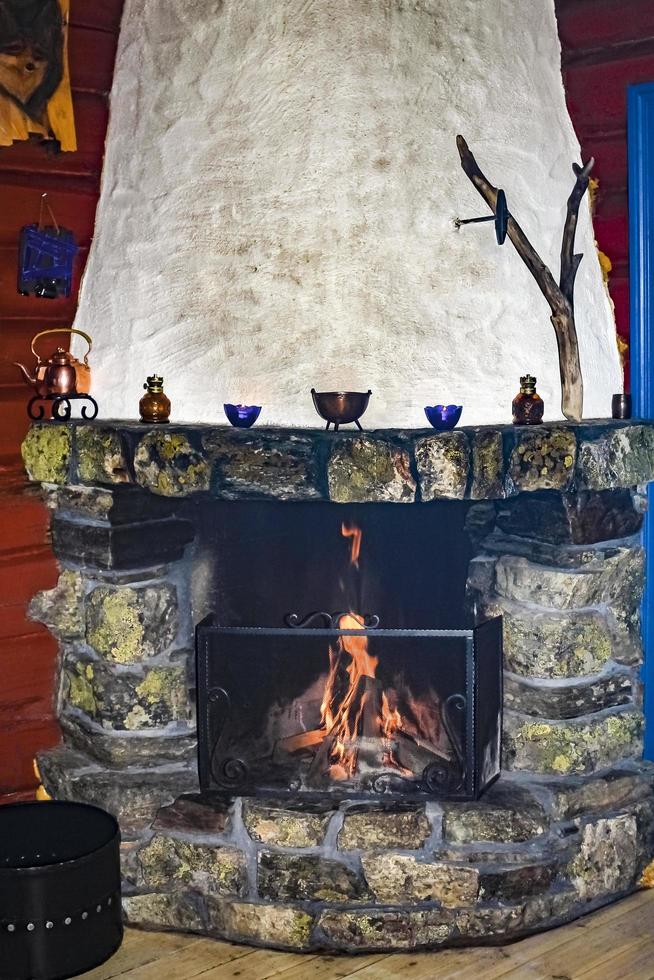 Old stone and wood fireplace in a Norwegian cabin, Hemsedal. photo