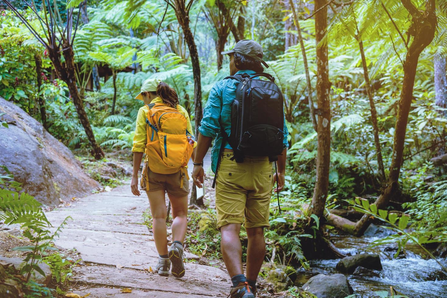 lover woman and man asian travel nature.Travel relax. Walking and studying nature in the forest. Thailand photo