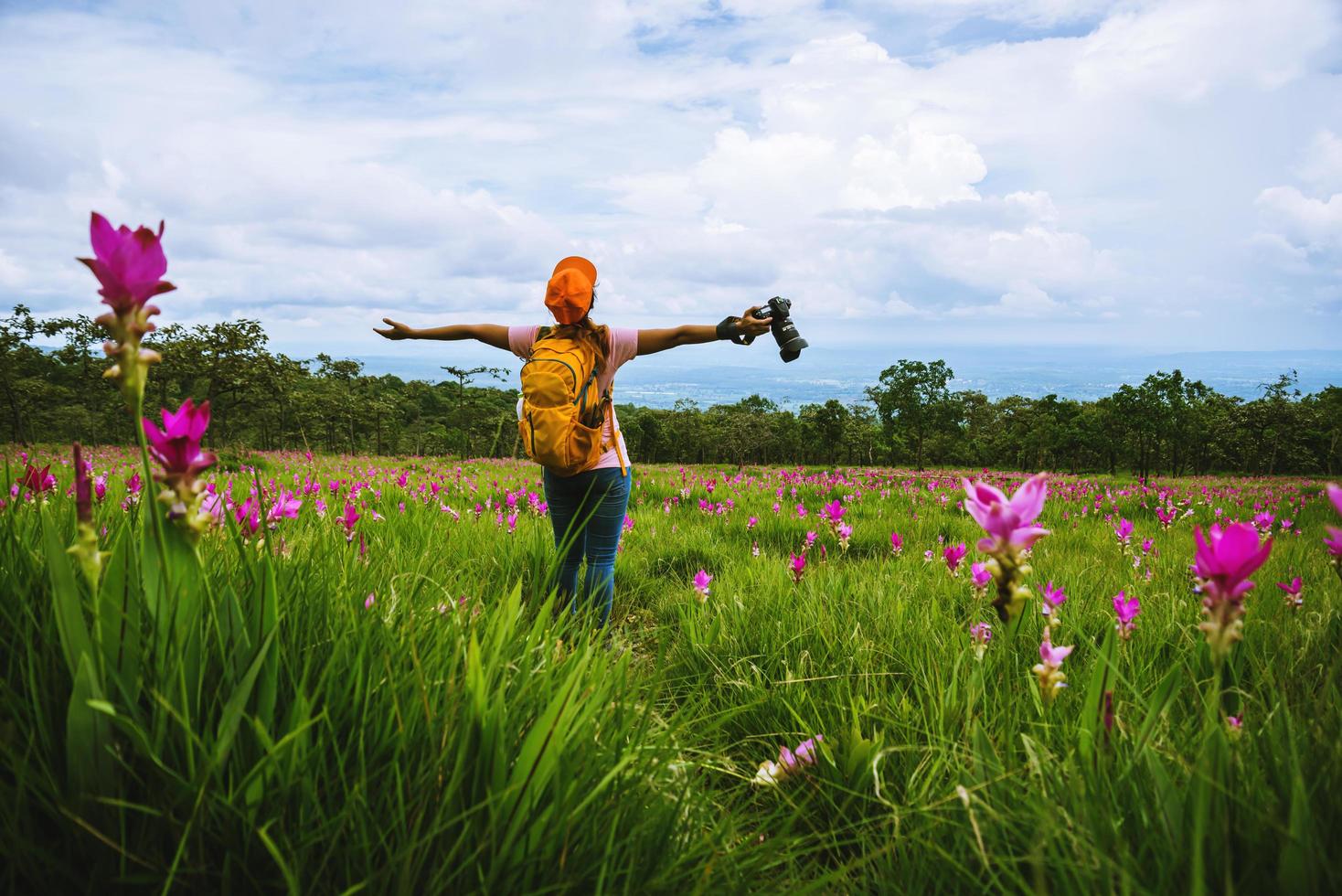 Asian woman travel nature. Travel relax. Photography Cucumber sessilis flower field. photo