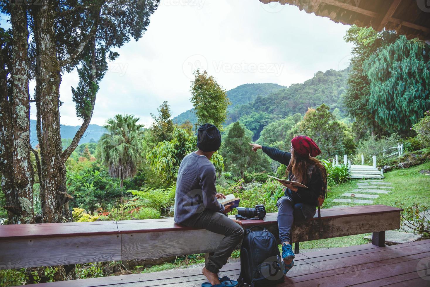 Asian couple travel photograph nature education. nature relax and study read a book. at public park. In Thailand photo
