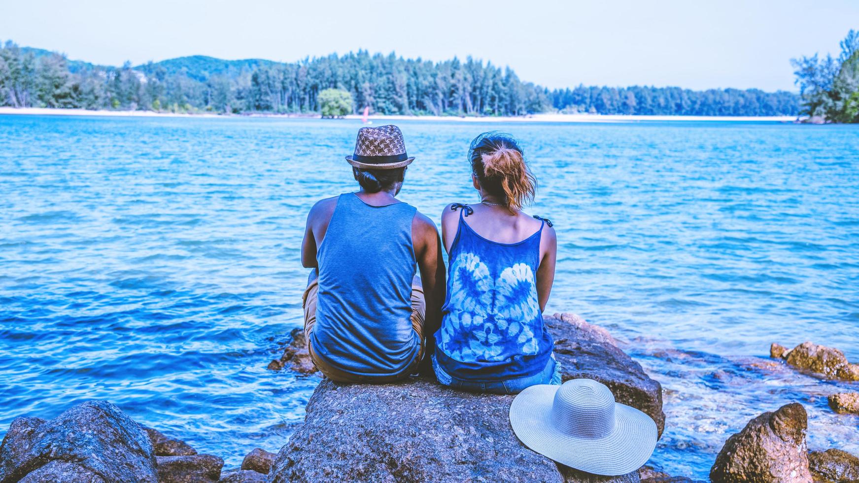 Asian lover woman and man travel nature. Travel relax. On the rocks at the sea. In the summer. Thailand photo