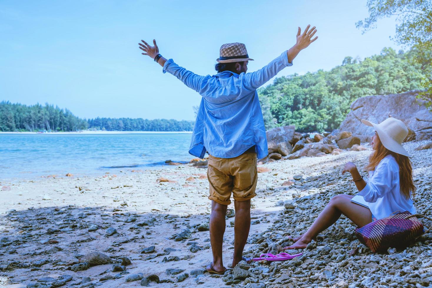 Asian lover couple women and men travel nature. Travel relax. Play sea water on the beach. In the summer. Thailand photo