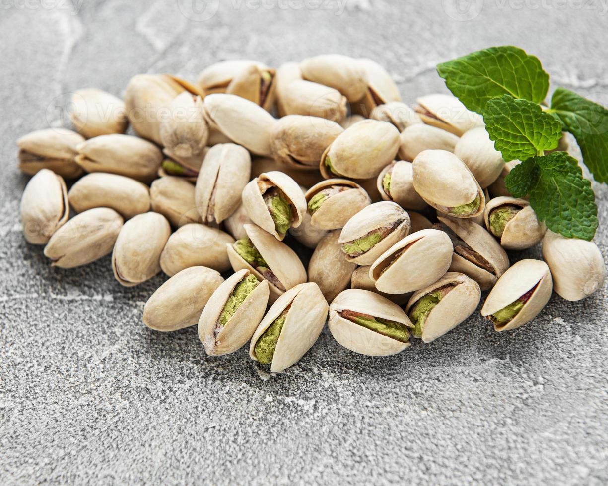 Pistachios nuts on concrete background photo