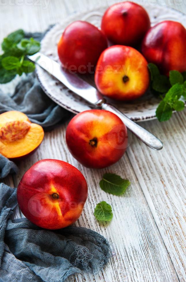 Plate with fresh nectarines photo