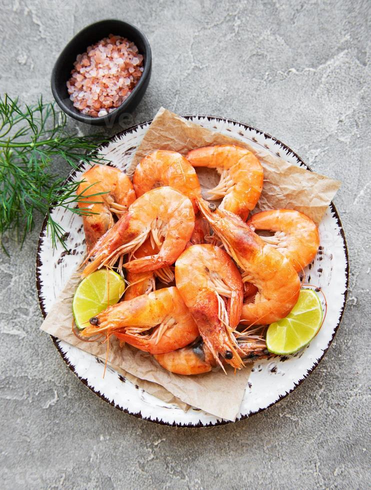 Shrimps or prawns served with lemon photo