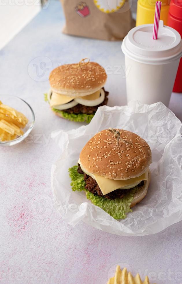 Set of homemade burgers, chips and drink photo