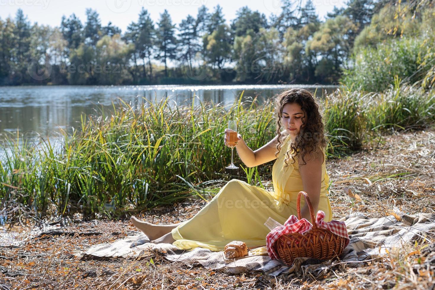 Beautiful woman in yellow dress on a picnic photo