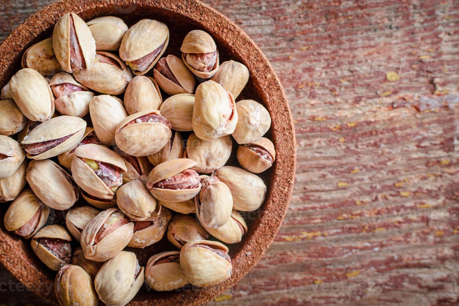 Pistachios on a wooden table photo
