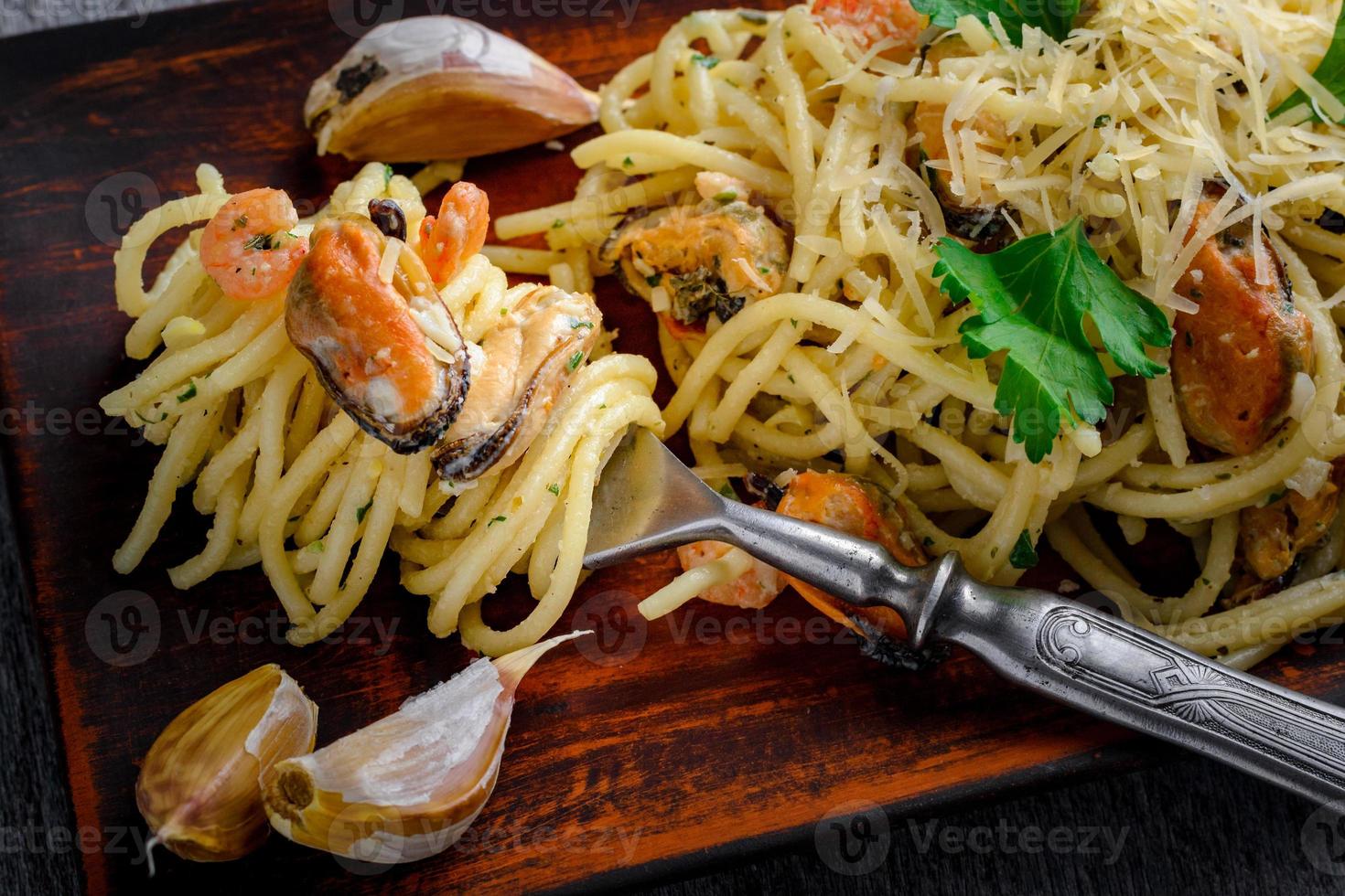 Italian pasta in a creamy sauce with seafood, shrimps and mussels on a plate photo