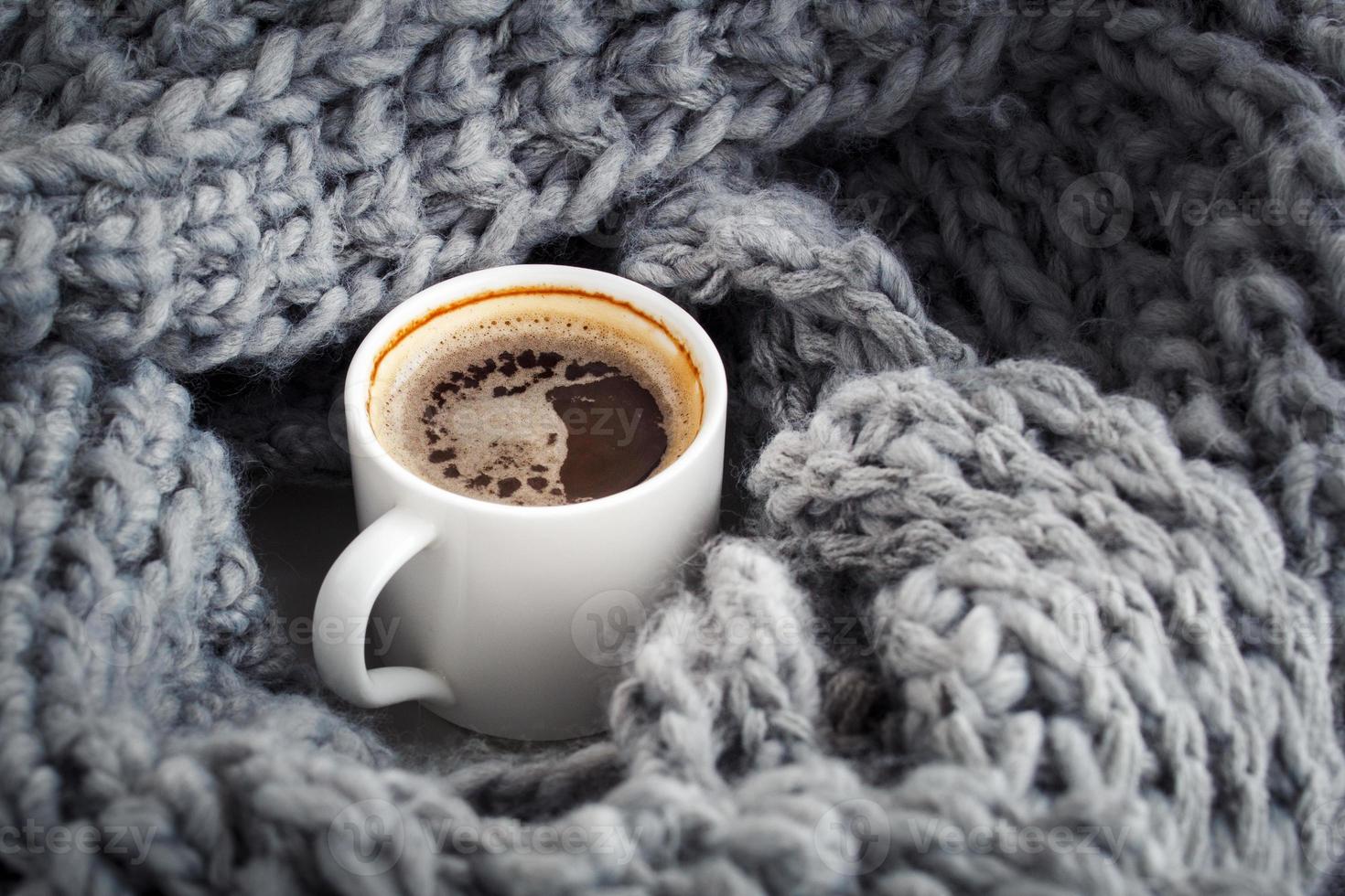 a cup of aromatic coffee wrapped in wool snod photo