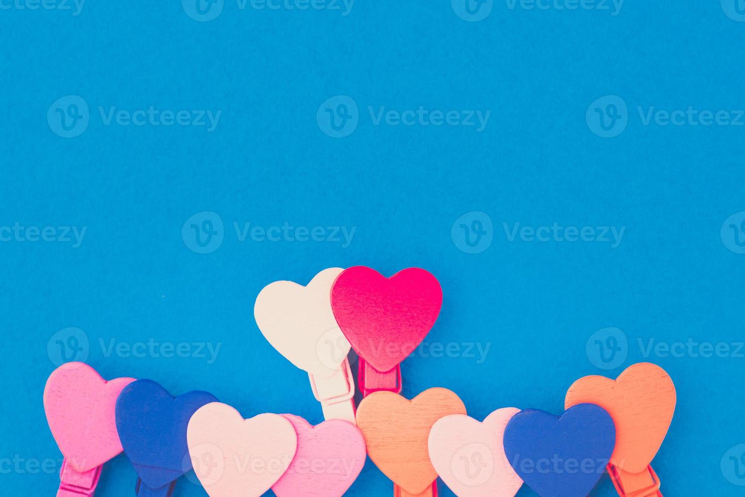 Loving couple of wooden hearts on a blue background photo