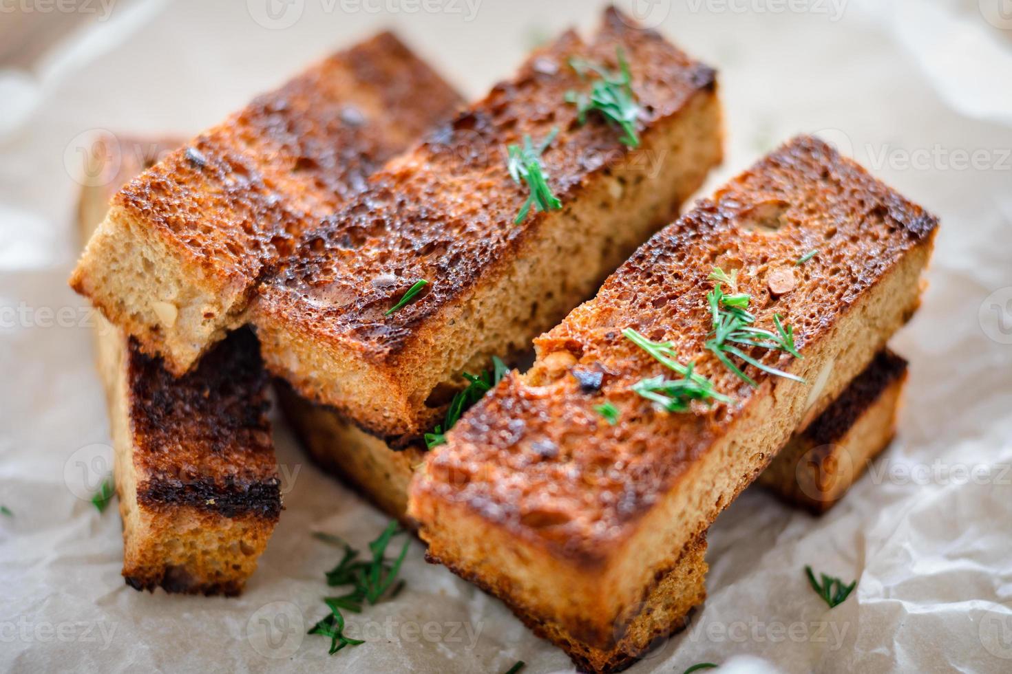 appetizing toasted toasts from rye bread with dill on white background. photo