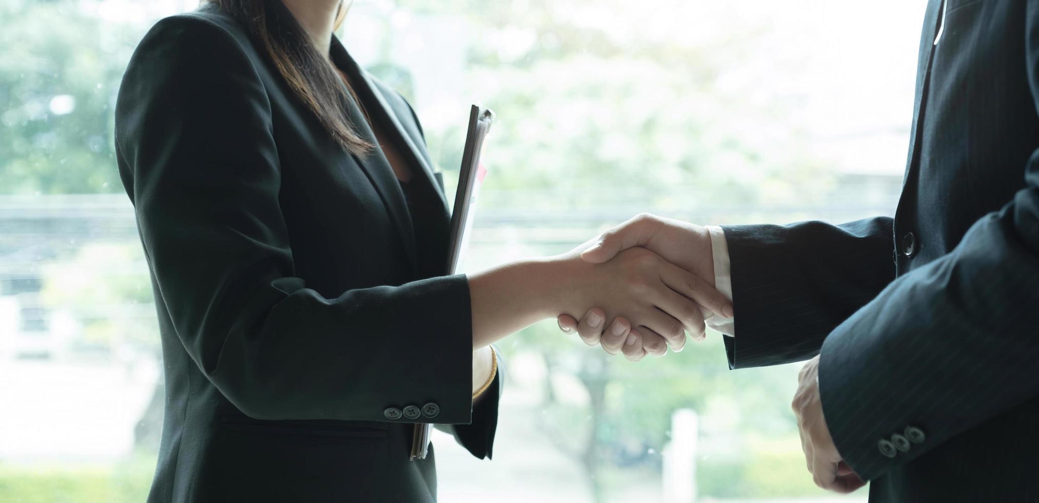 Business partnership meeting concept. Image businessmans handshake. Successful businessmen handshaking after good deal. Group support concept. photo