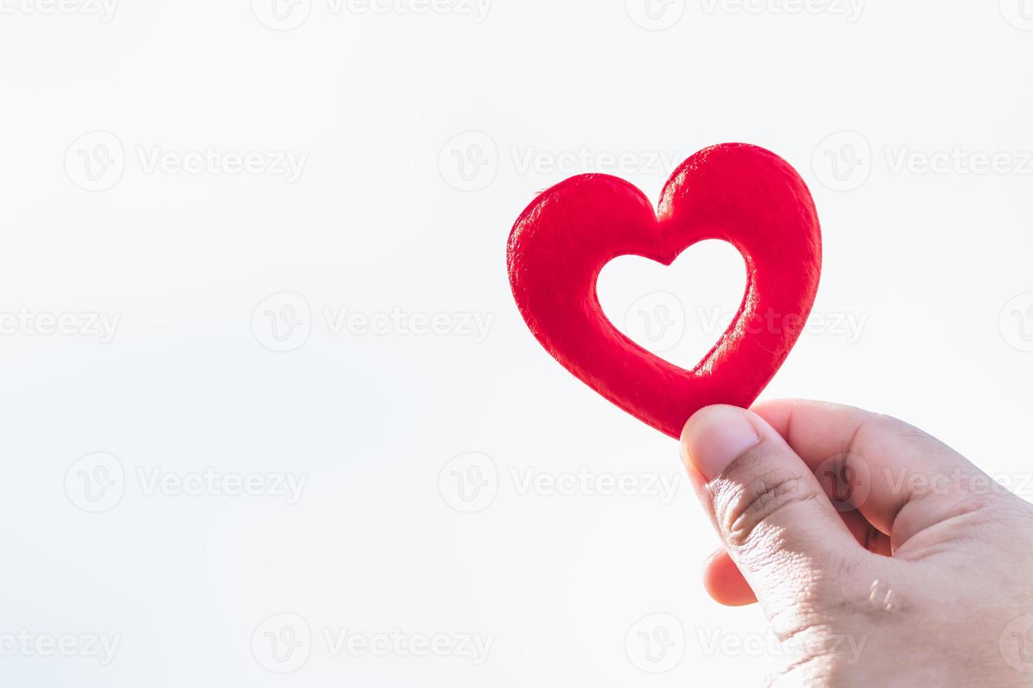Human hands holding red hearth on isolated white background. Valentine's day concept. Copy space. photo