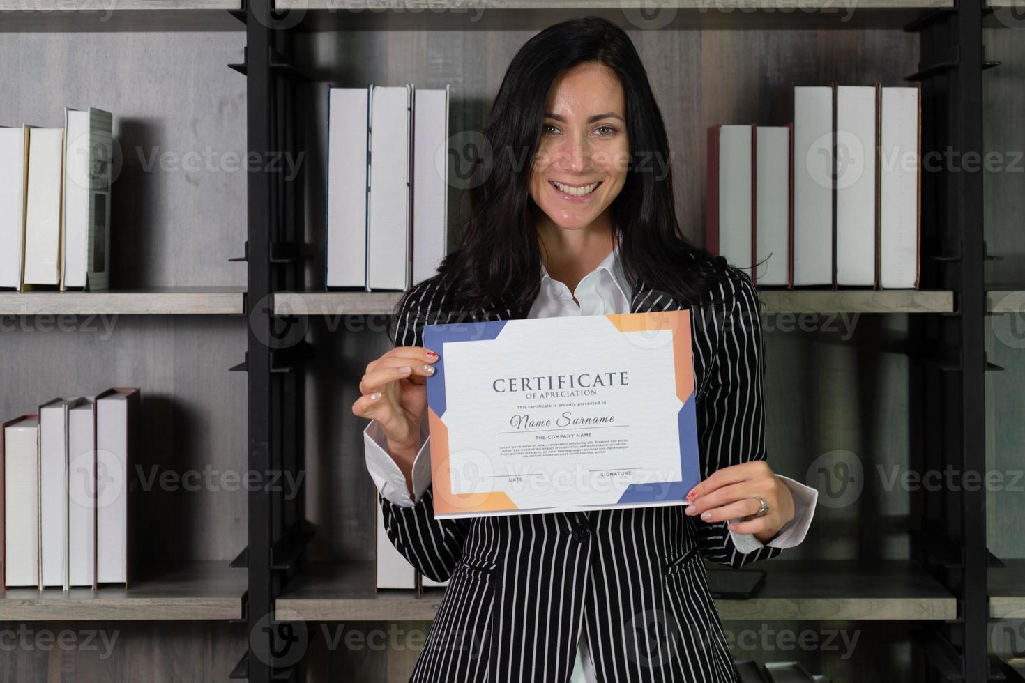 candid portrait of young beautiful caucasian businesswoman getting certificate of appreciation. business concept photo