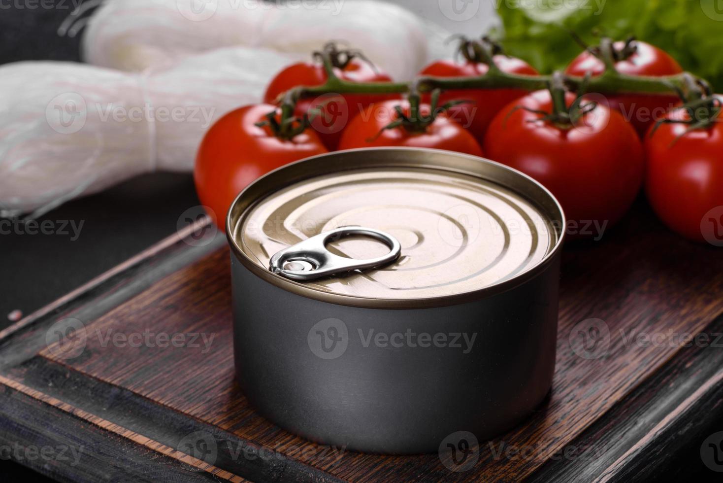 Canned delicious fresh tuna in oil with salt and spices in a tin can photo