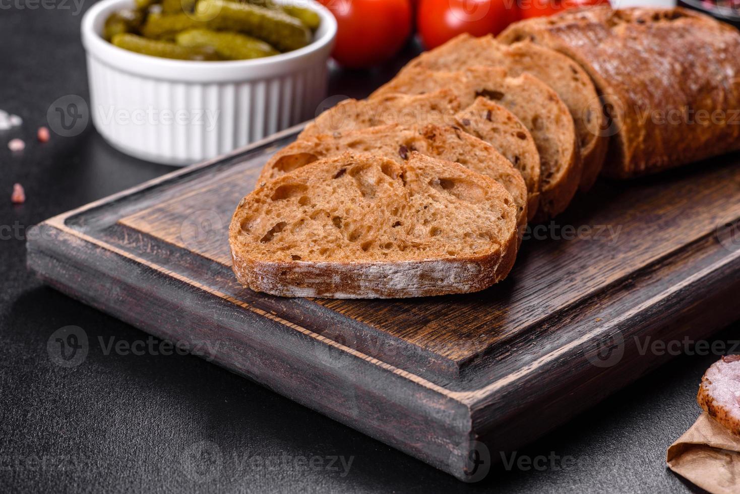 Delicious fresh bacon sliced with bread and vegetables photo