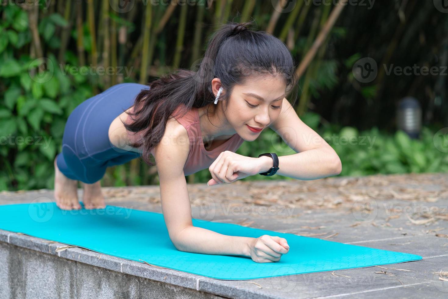 Young Asian woman doing exercise in the park photo