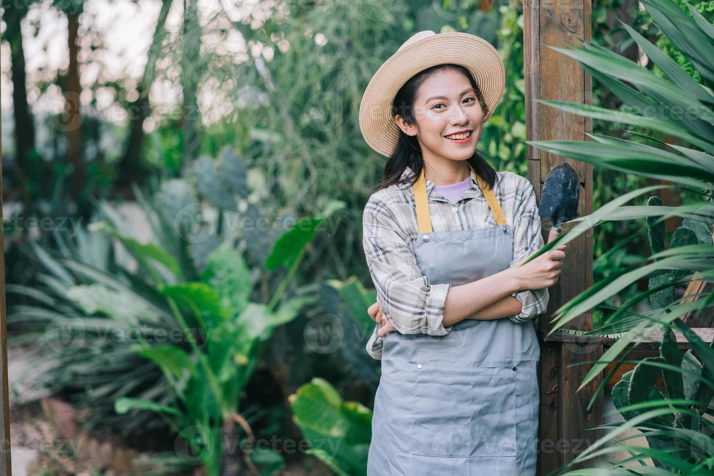 Young Asian woman takes care of the garden photo