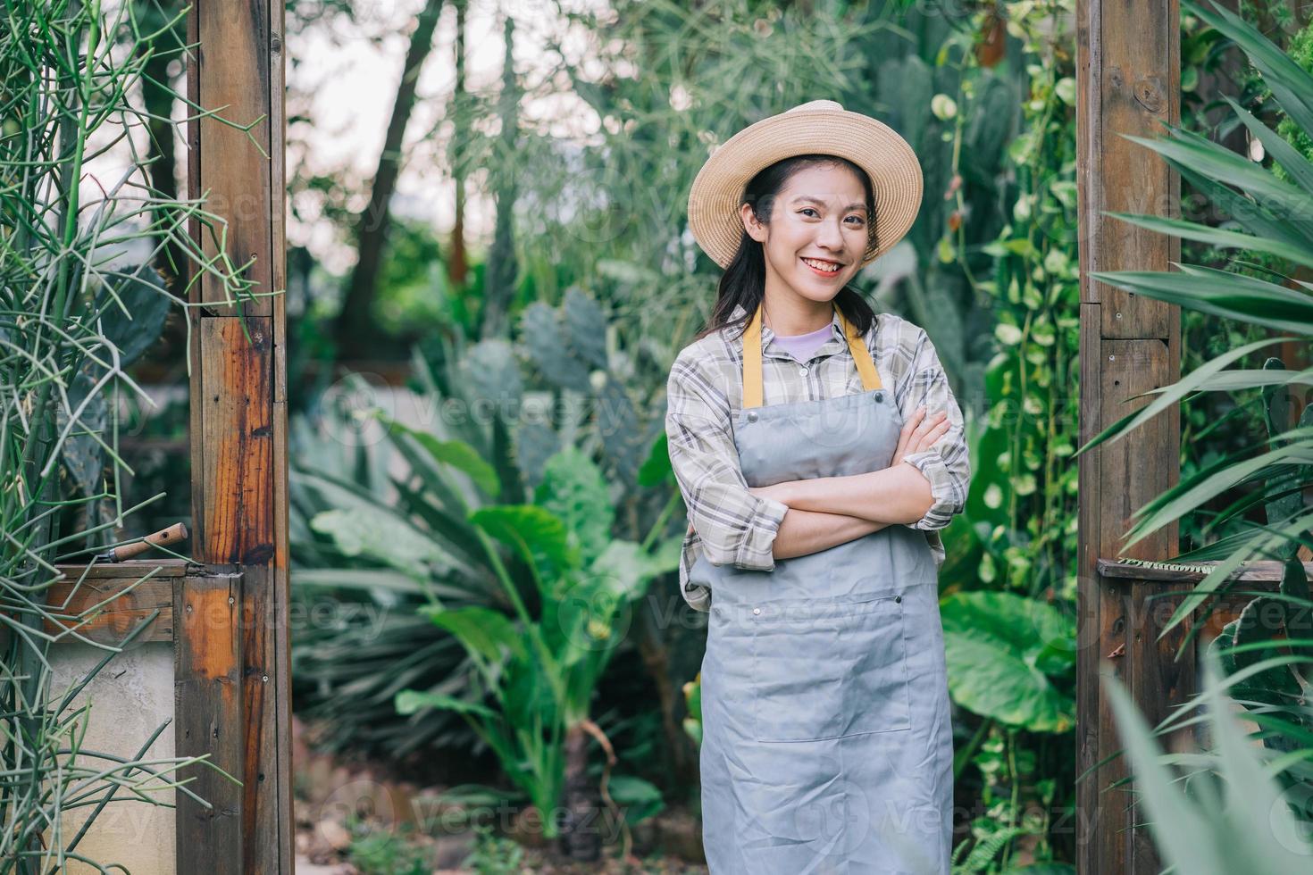 Young Asian woman takes care of the garden photo