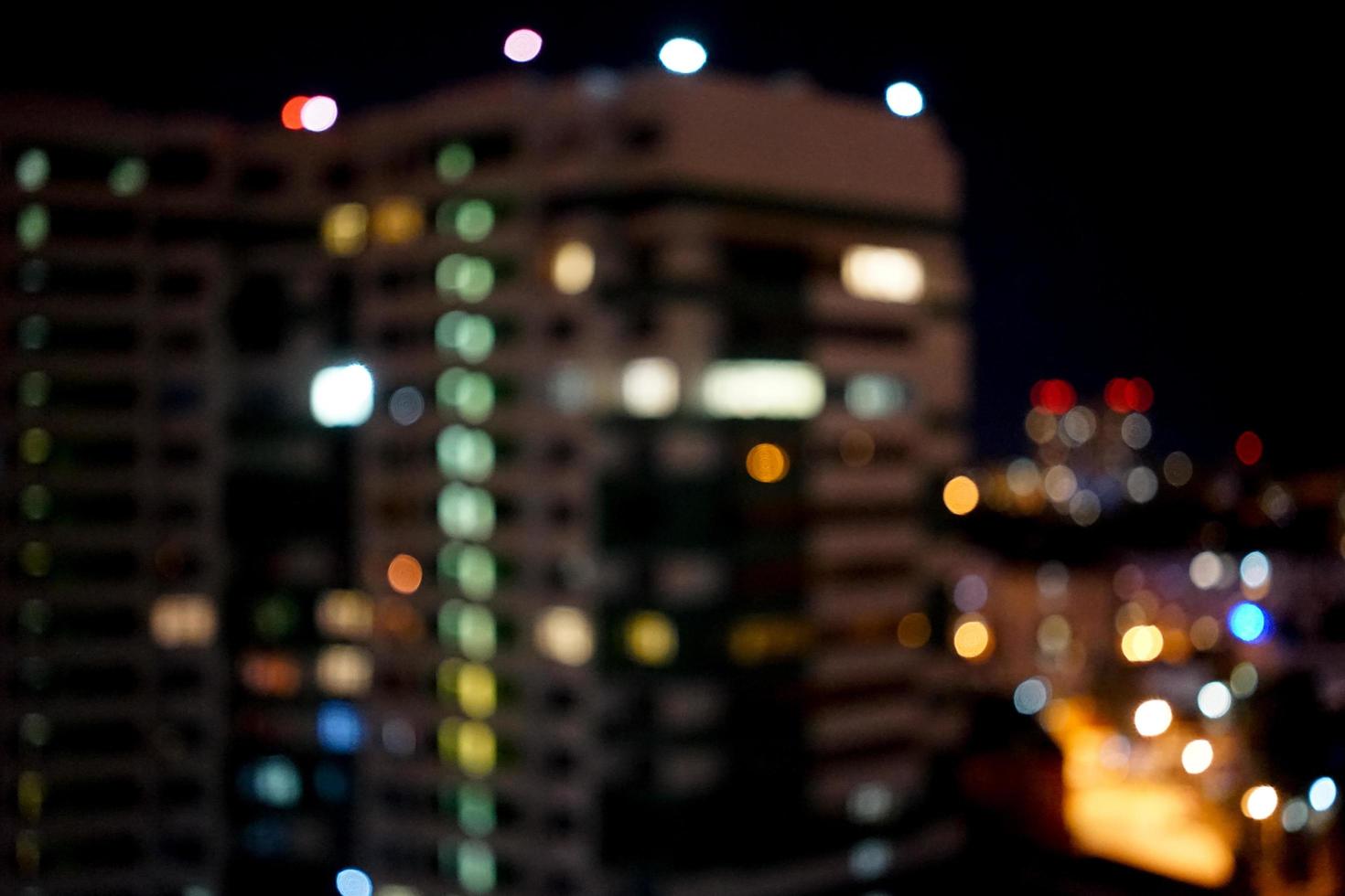 blurred night background with a view of high-rise buildings and lots of lights photo